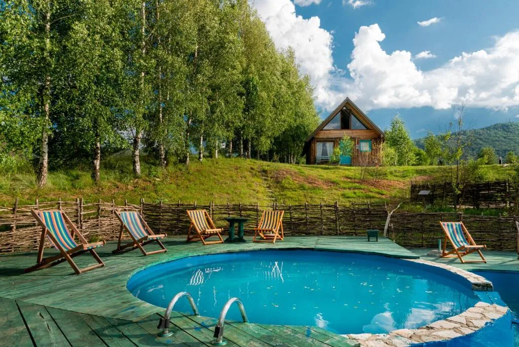 Outdoor swimming pool at Ethno Village Montenegro in Brezna, surrounded by greenery